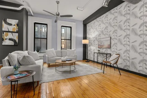 a living room with furniture and wooden floor