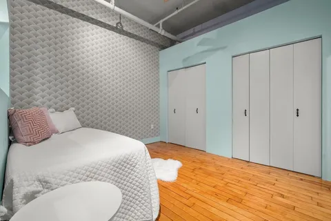 a bedroom with a bed and a mirror