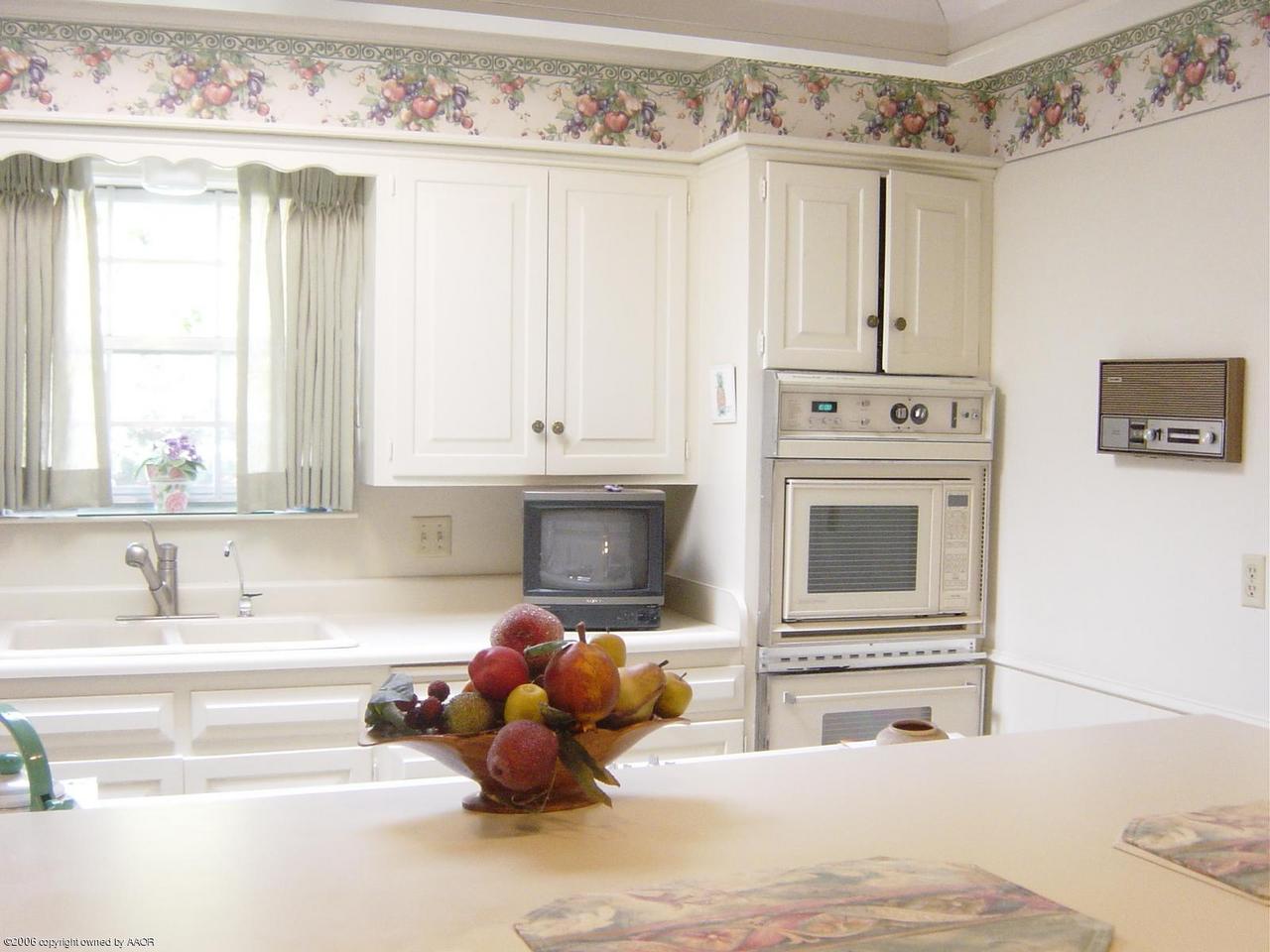 6312 Jameson Road Amarillo, TX 79106 - Photo 4 of 15 a kitchen with a cabinets and white appliances