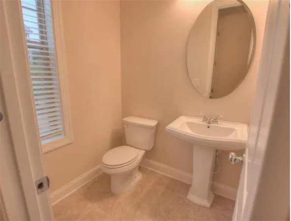 a bathroom with a sink toilet and mirror