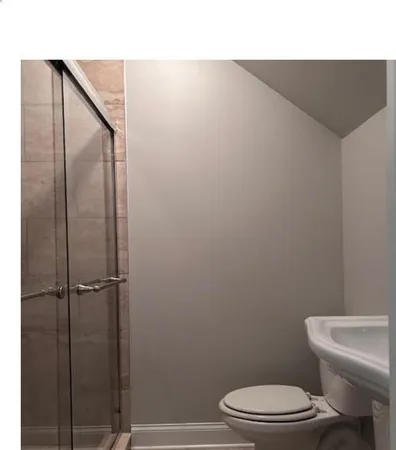 a bathroom with a toilet a sink and shower