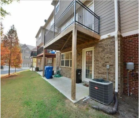 a view of a house with a yard and sitting area