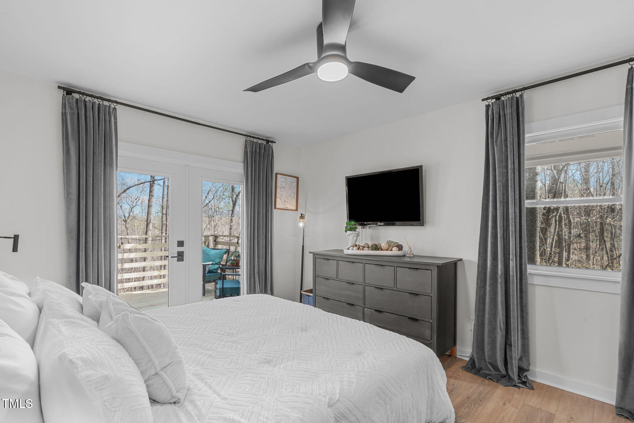 211 Fleming Drive Durham, NC 27712 - Photo 18 of 34 a bedroom with a bed and a flat screen tv