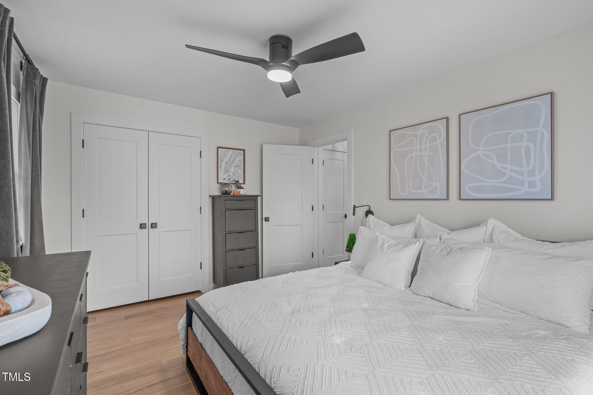 211 Fleming Drive Durham, NC 27712 - Photo 20 of 34 a spacious bedroom with a bed and a dresser