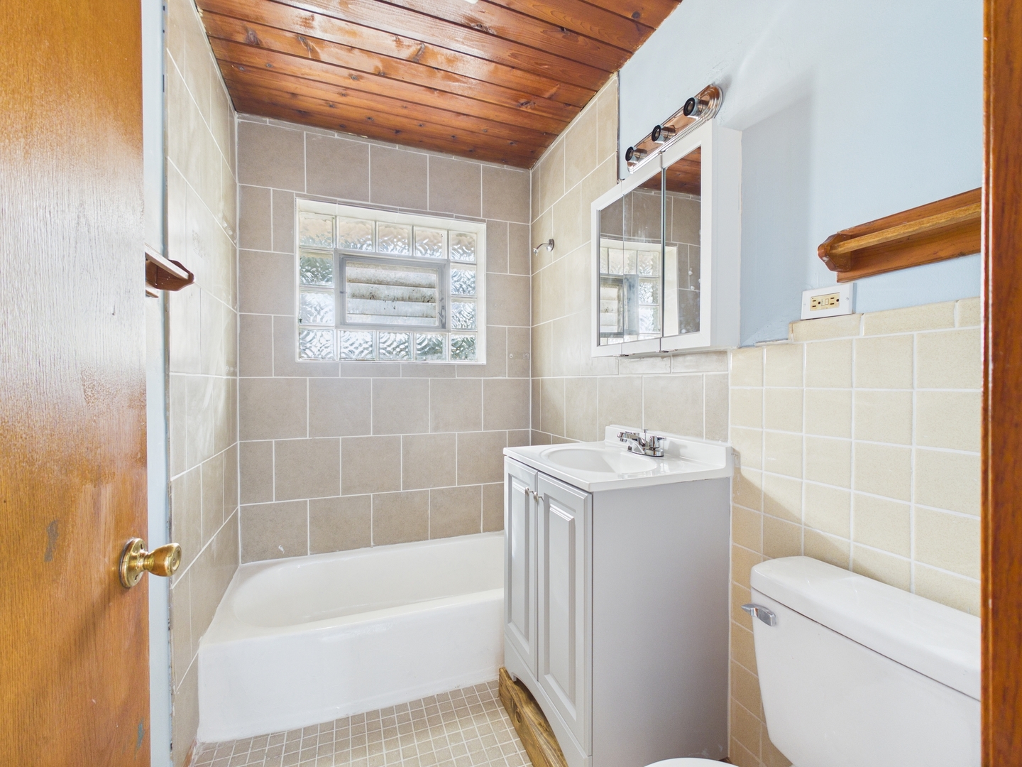 a bathroom with a sink a toilet and bathtub