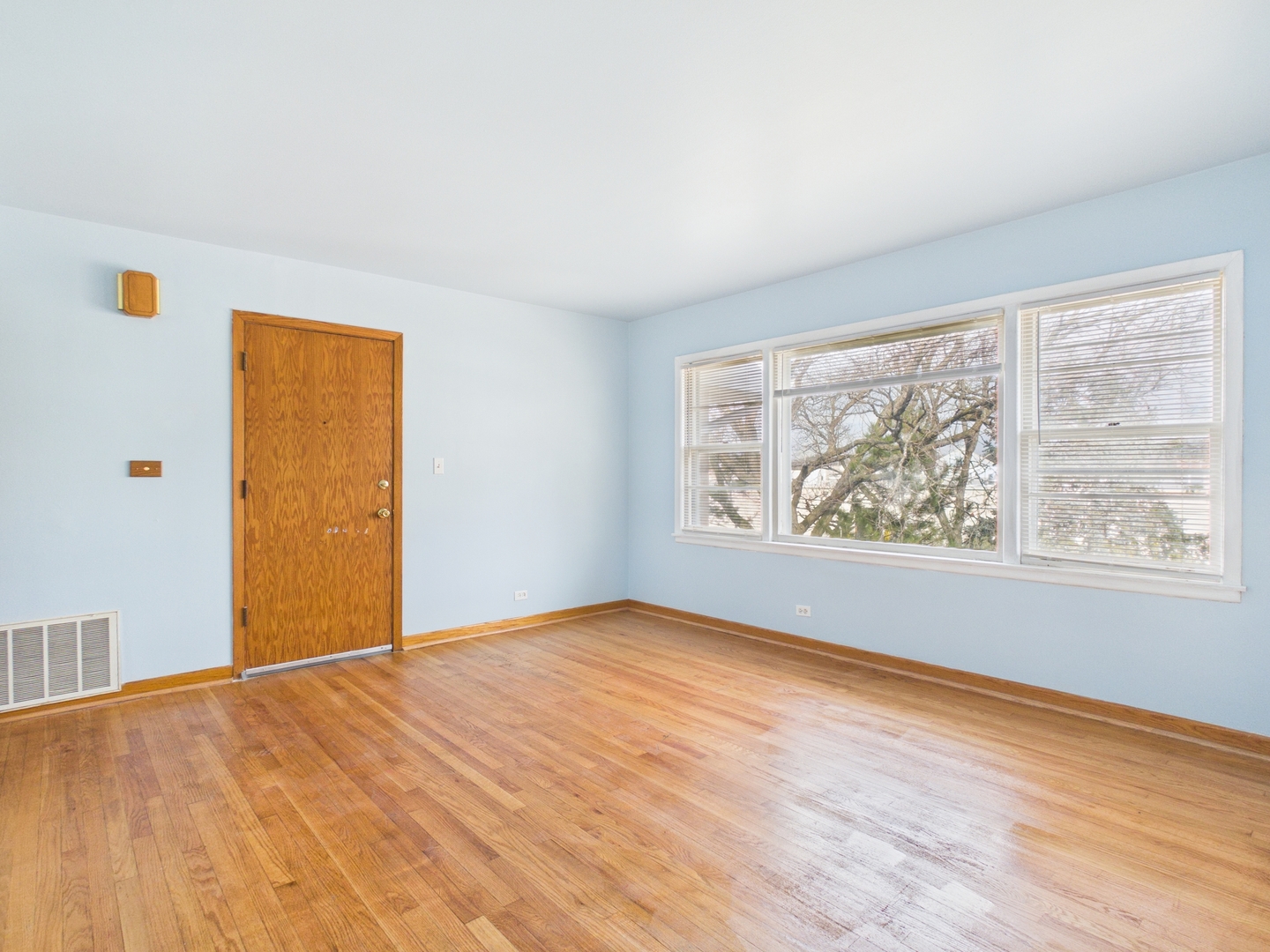 755 Dulles Road, Unit E Des Plaines, IL 60016 - Photo 2 of 7 a view of an empty room with wooden floor and a window