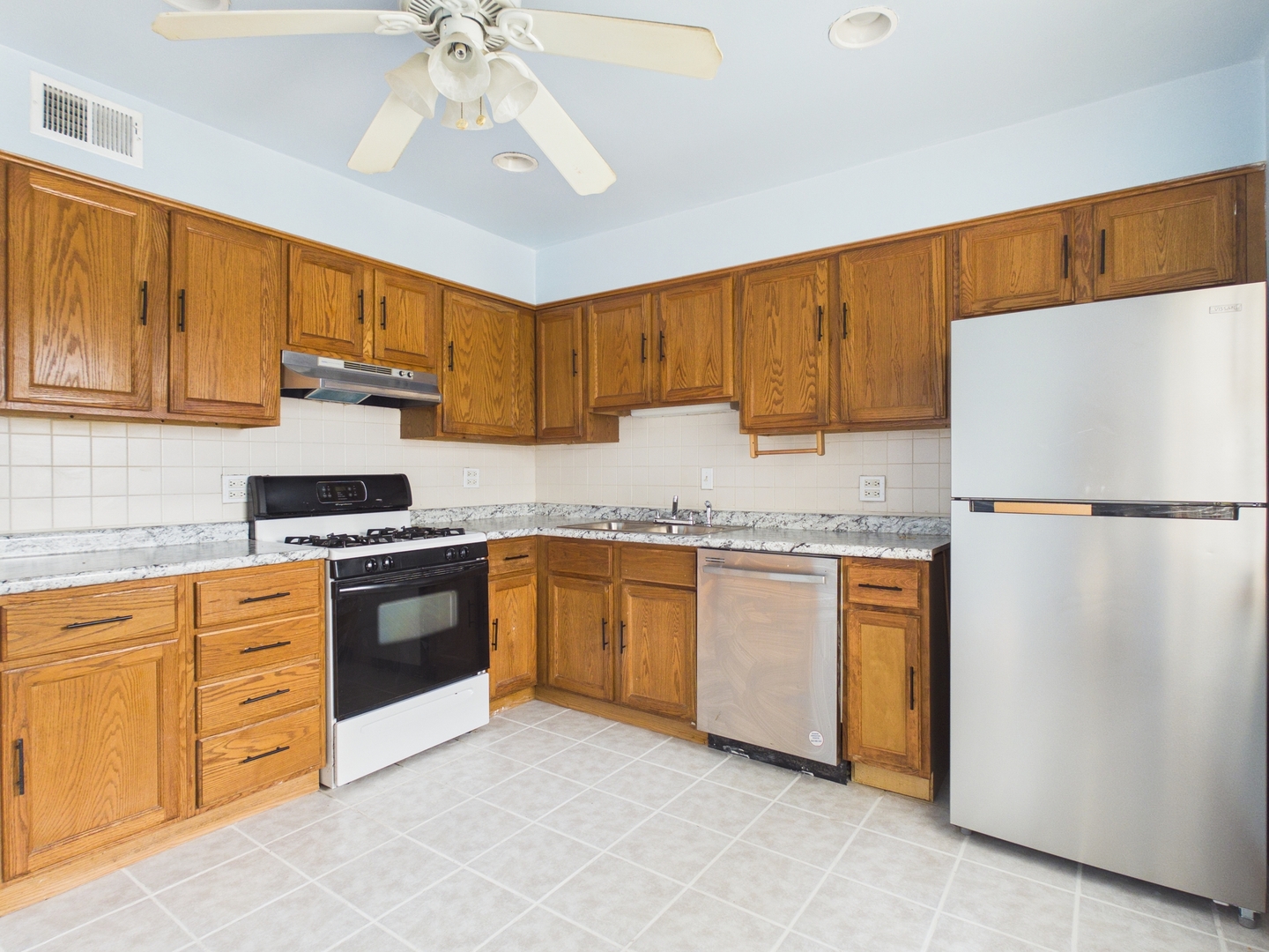 755 Dulles Road, Unit E Des Plaines, IL 60016 - Photo 3 of 7 a kitchen with granite countertop a refrigerator sink and cabinets