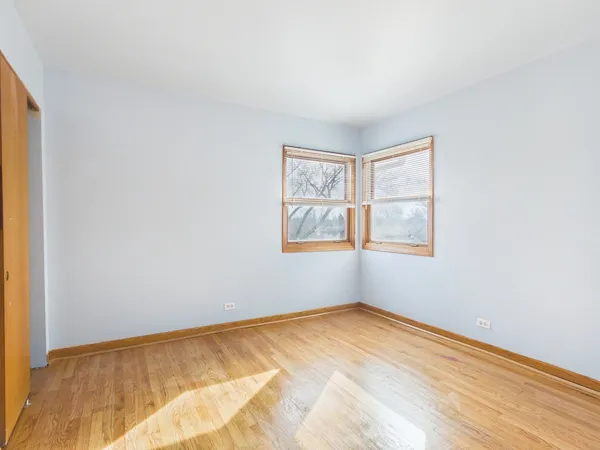 a view of a room with wooden floor and window