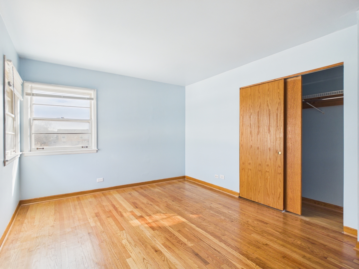 755 Dulles Road, Unit E Des Plaines, IL 60016 - Photo 6 of 7 a view of empty room with wooden floor and fan