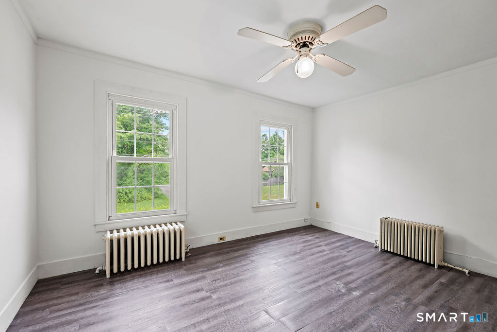 88 Powder Hill Road Middlefield, CT 06455 - Photo 25 of 40 a view of an empty room with wooden floor and a window