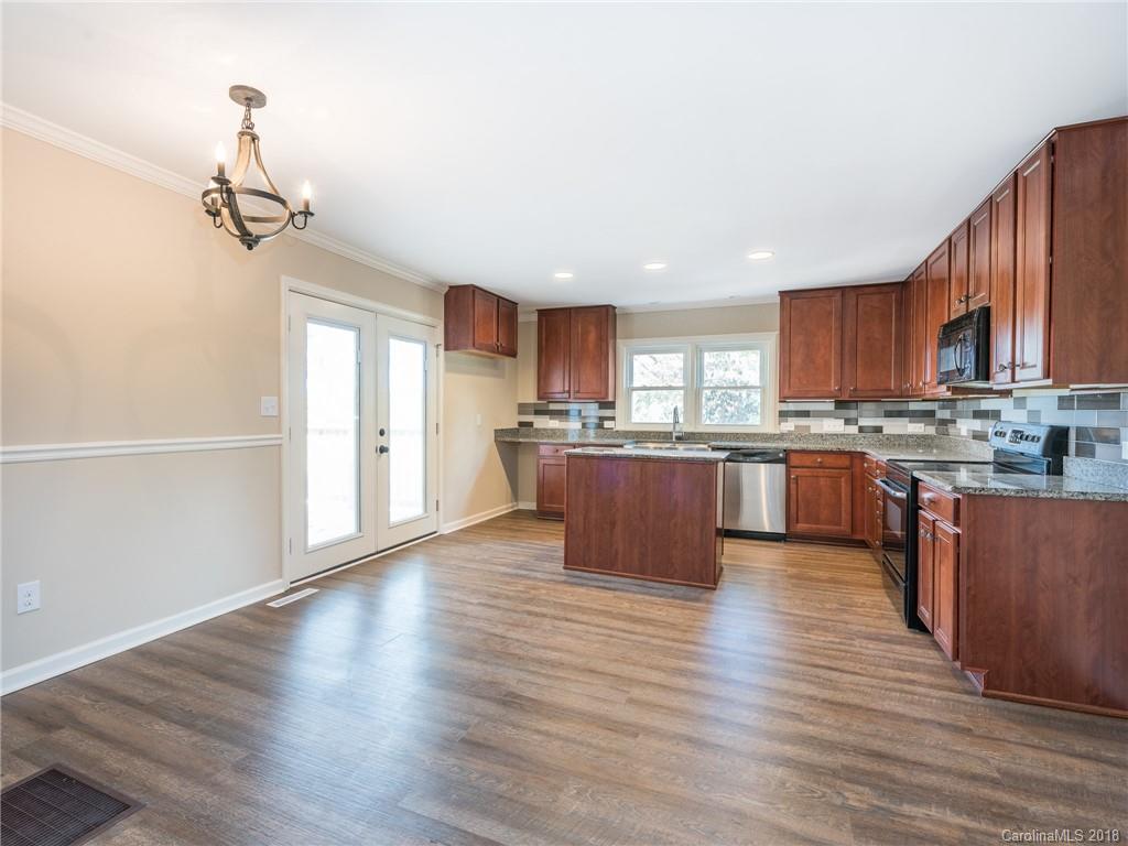 2022 Long Hope Road Monroe, NC 28112 - Photo 12 of 28 a large kitchen with wooden floors and wooden cabinets