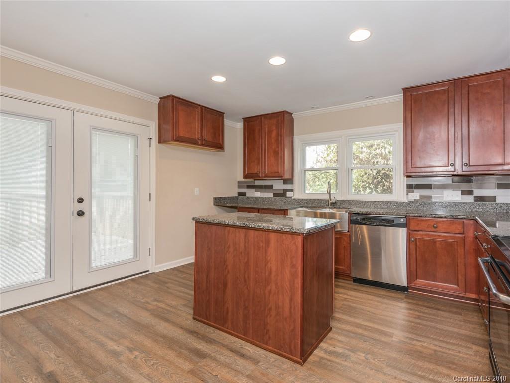 2022 Long Hope Road Monroe, NC 28112 - Photo 13 of 28 a kitchen with stainless steel appliances granite countertop a stove a sink dishwasher and a refrigerator