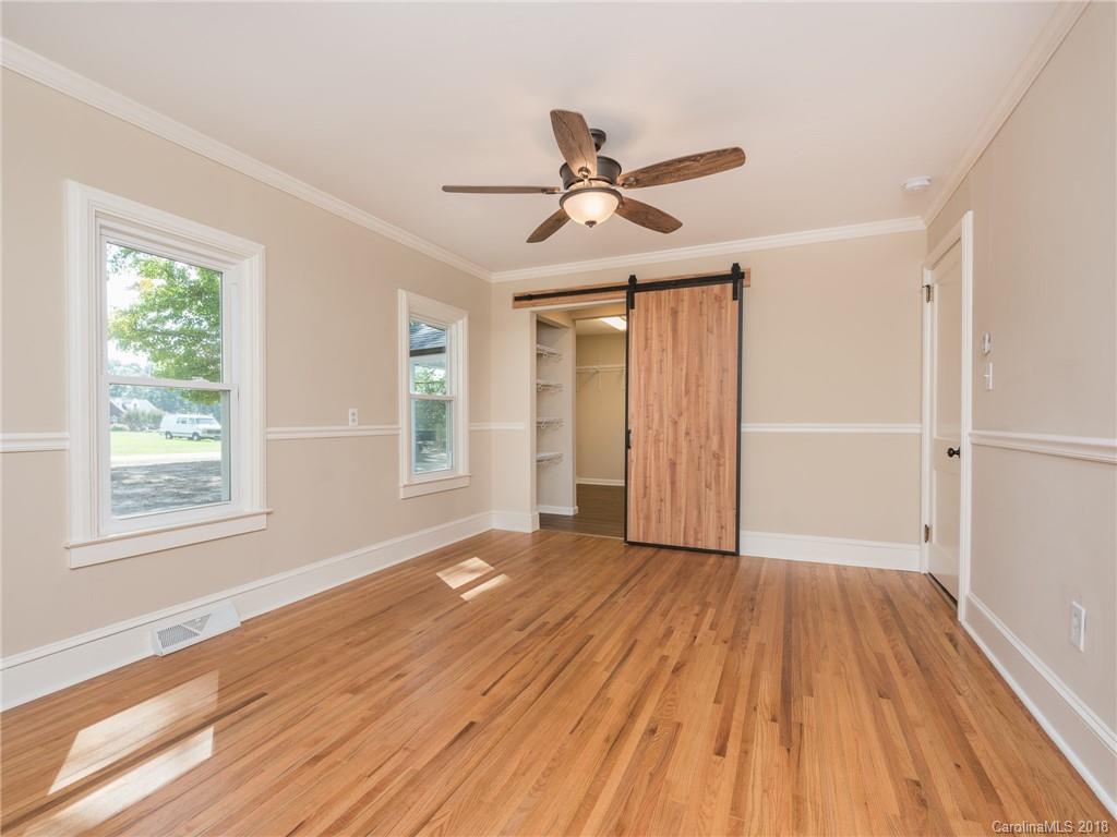 2022 Long Hope Road Monroe, NC 28112 - Photo 15 of 28 a view of an empty room with wooden floor and a window