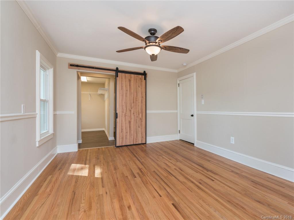2022 Long Hope Road Monroe, NC 28112 - Photo 16 of 28 a view of an empty room with wooden floor and a ceiling fan
