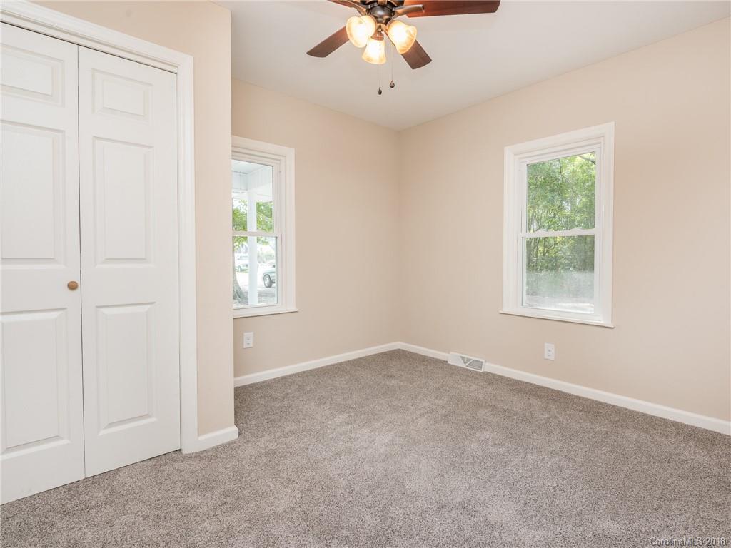 2022 Long Hope Road Monroe, NC 28112 - Photo 19 of 28 an empty room with windows and chandelier fan