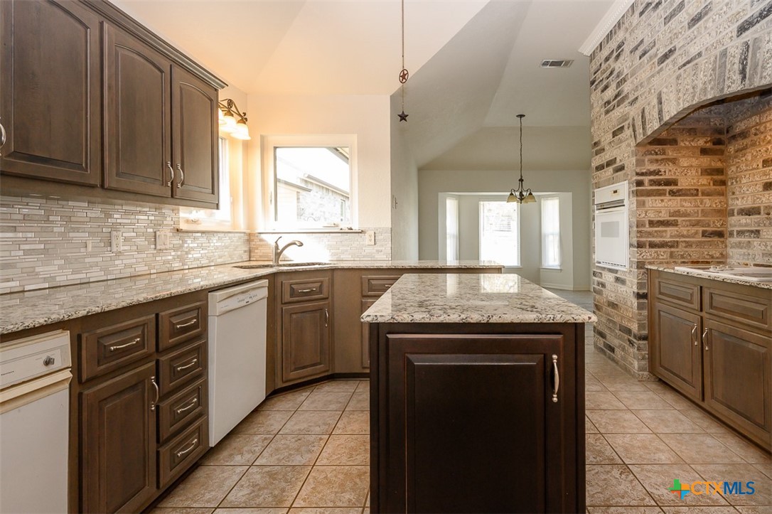 138 County Road 4963 Kempner, TX 76539 - Photo 12 of 46 a kitchen with stainless steel appliances granite countertop a stove sink and cabinets