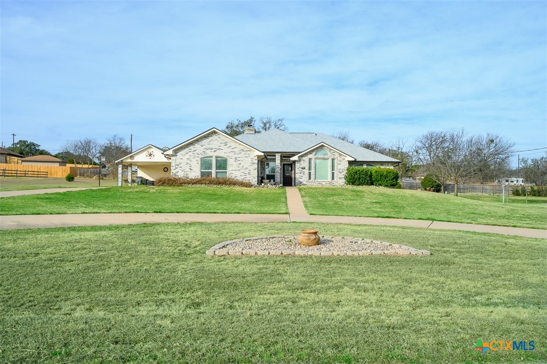 138 County Road 4963 Kempner, TX 76539 - Photo 2 of 46 a front view of a house with a garden and trees