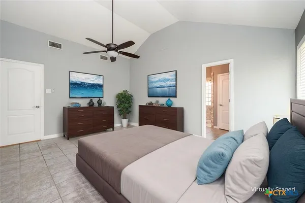a living room with a bed furniture and a flat screen tv