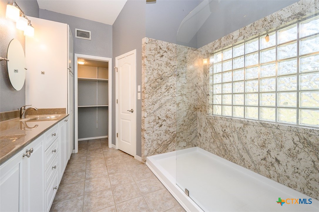 138 County Road 4963 Kempner, TX 76539 - Photo 25 of 46 a bathroom with a granite countertop sink a bathtub and a shower