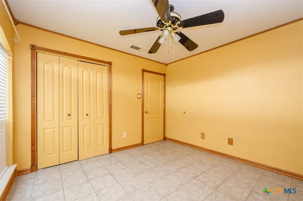 a view of a bathroom with a shower and a ceiling fan