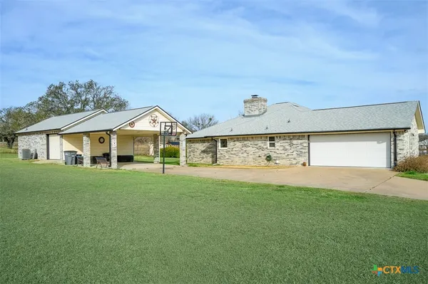 a view of a house with a yard and garage