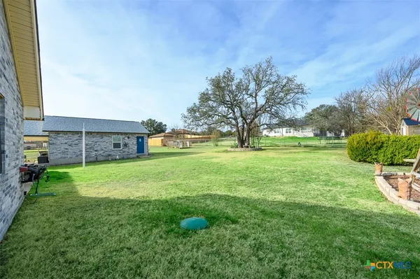 a view of outdoor space with deck and yard