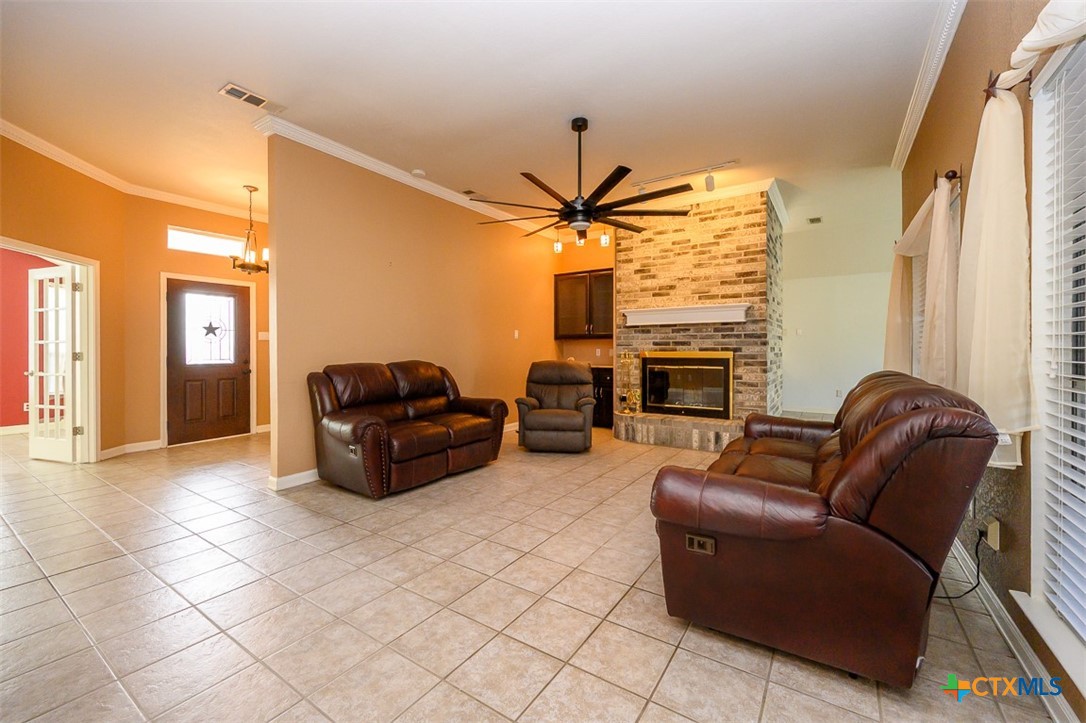 138 County Road 4963 Kempner, TX 76539 - Photo 4 of 46 a living room with furniture a fireplace and a flat screen tv