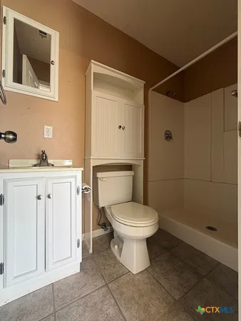 a white toilet sitting next to a bathroom sink