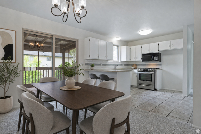 1722 Kimsbrough Road Sandy, UT 84092 - Photo 8 of 29 Dining area featuring a contemporary chandelier and sliding glass doors opening to a screened porch