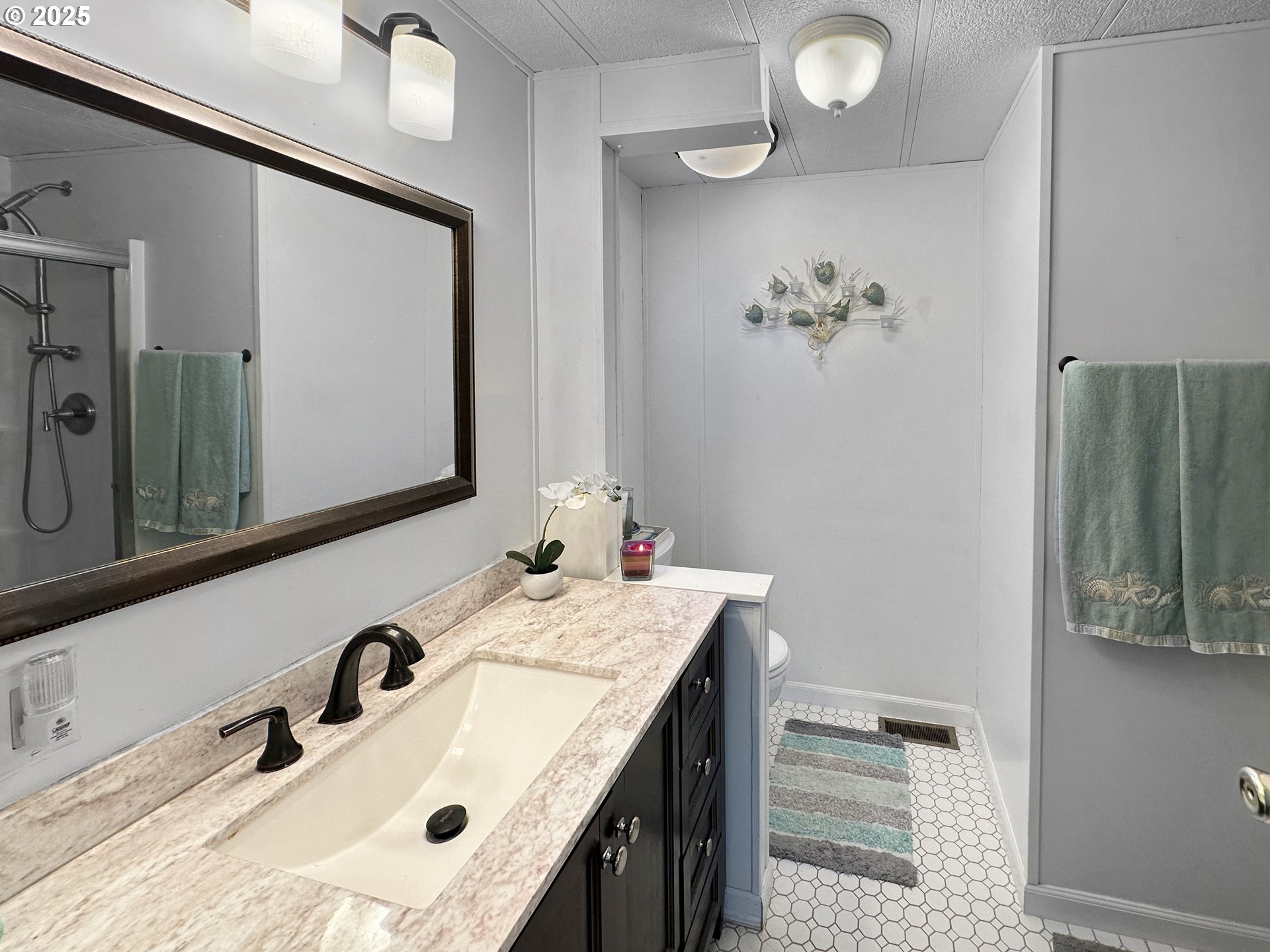 15889 Sunset Strip, Unit 35 Brookings, OR 97415 - Photo 11 of 21 a bathroom with a sink vanity and a mirror