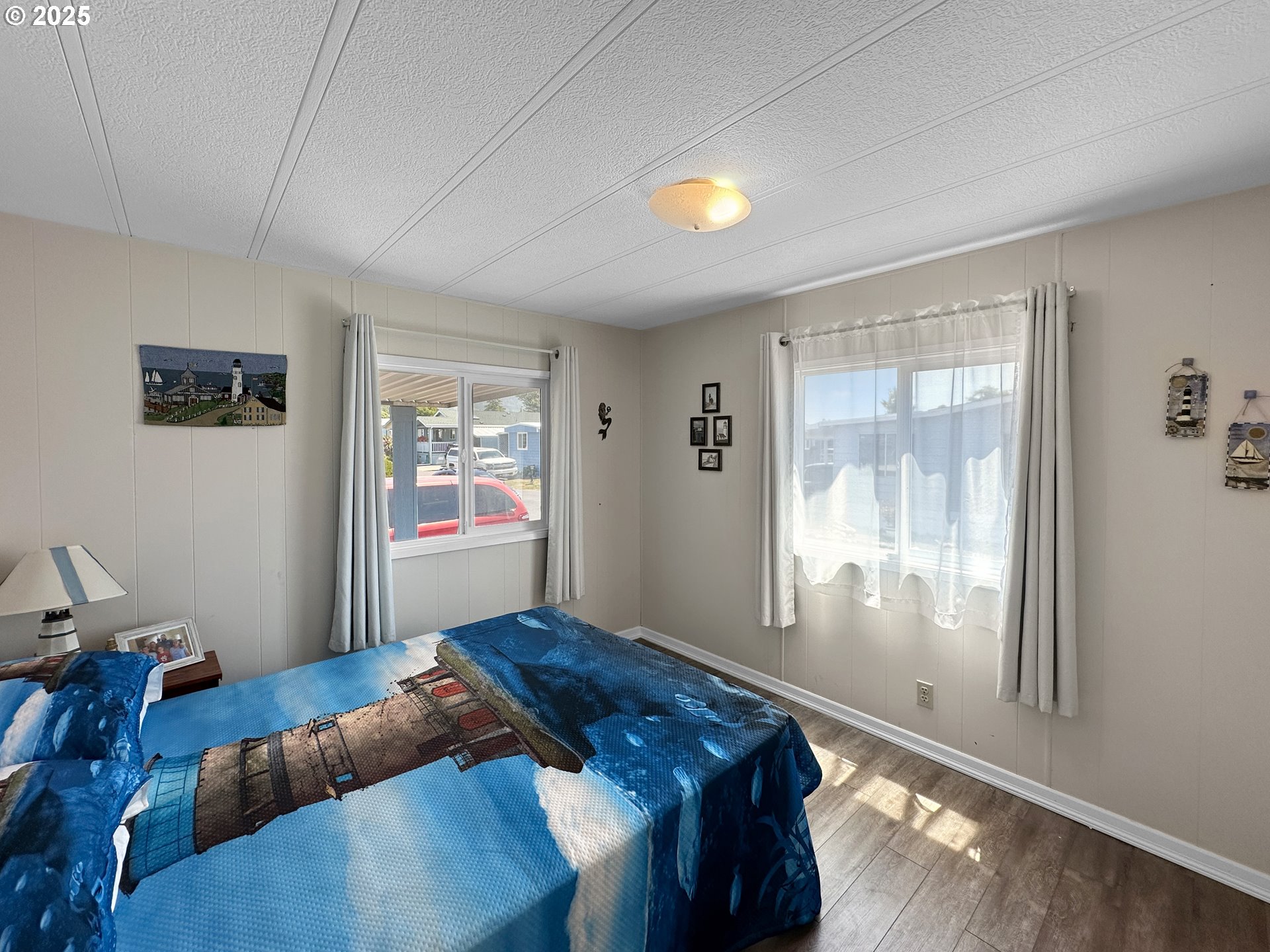 15889 Sunset Strip, Unit 35 Brookings, OR 97415 - Photo 16 of 21 a bedroom with bed and glass window