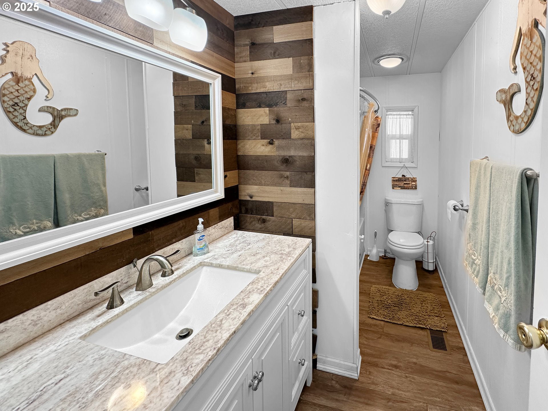 15889 Sunset Strip, Unit 35 Brookings, OR 97415 - Photo 17 of 21 a bathroom with a sink and a mirror