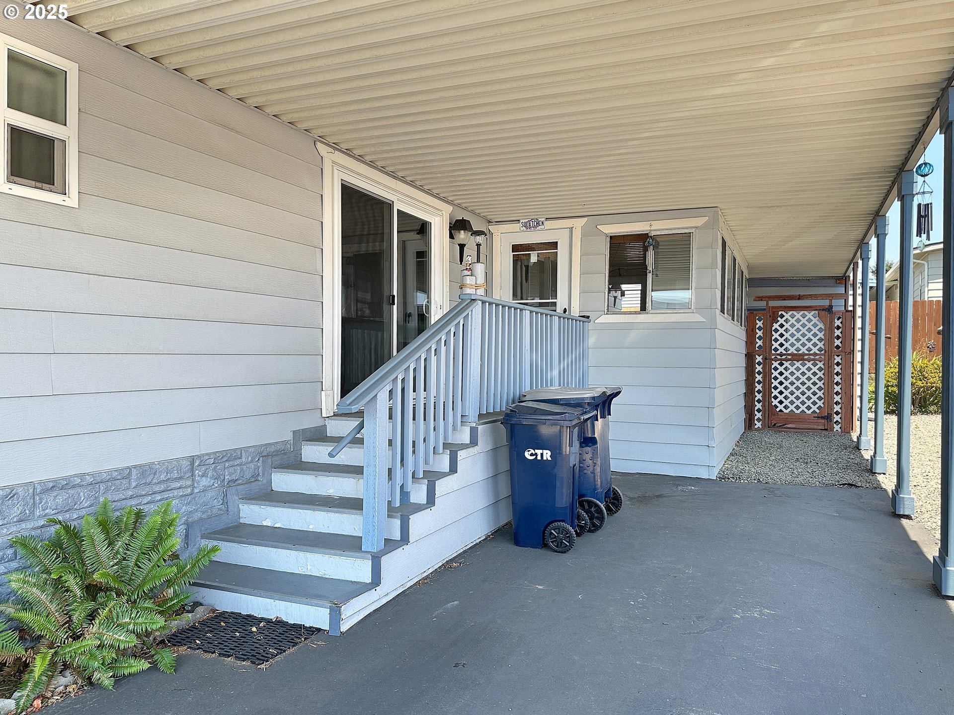 15889 Sunset Strip, Unit 35 Brookings, OR 97415 - Photo 3 of 21 a view of a house with wooden floor and a fence