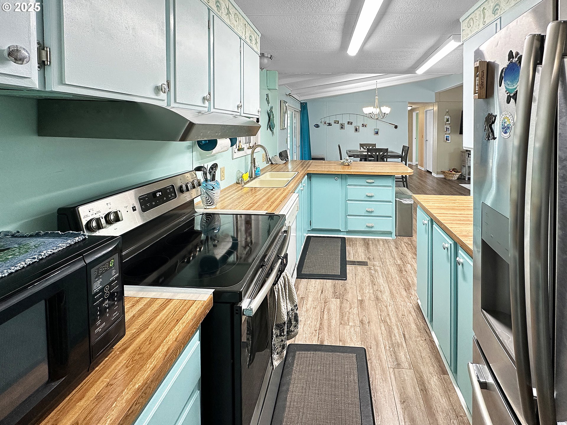 15889 Sunset Strip, Unit 35 Brookings, OR 97415 - Photo 8 of 21 a kitchen with stainless steel appliances granite countertop a stove and a refrigerator