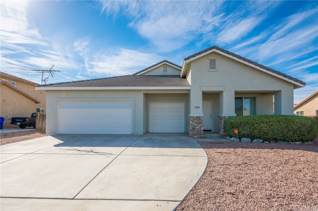 13224 Pacoima Road Victorville, CA 92392 - Photo 1 of 1 a front view of a house with a yard