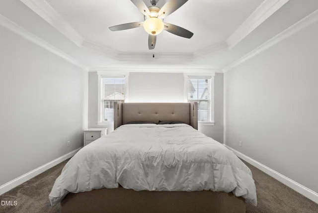 a bedroom with a bed and a ceiling fan