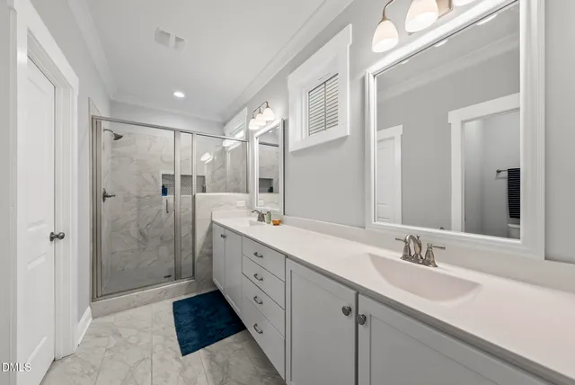 a bathroom with a double vanity sink mirror double shower and a