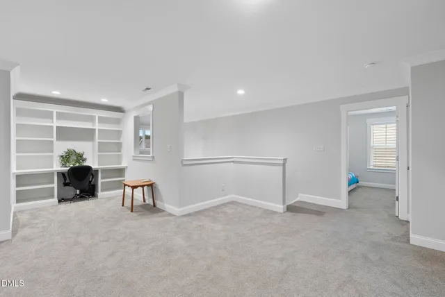 a view of empty room with wooden floor and furniture