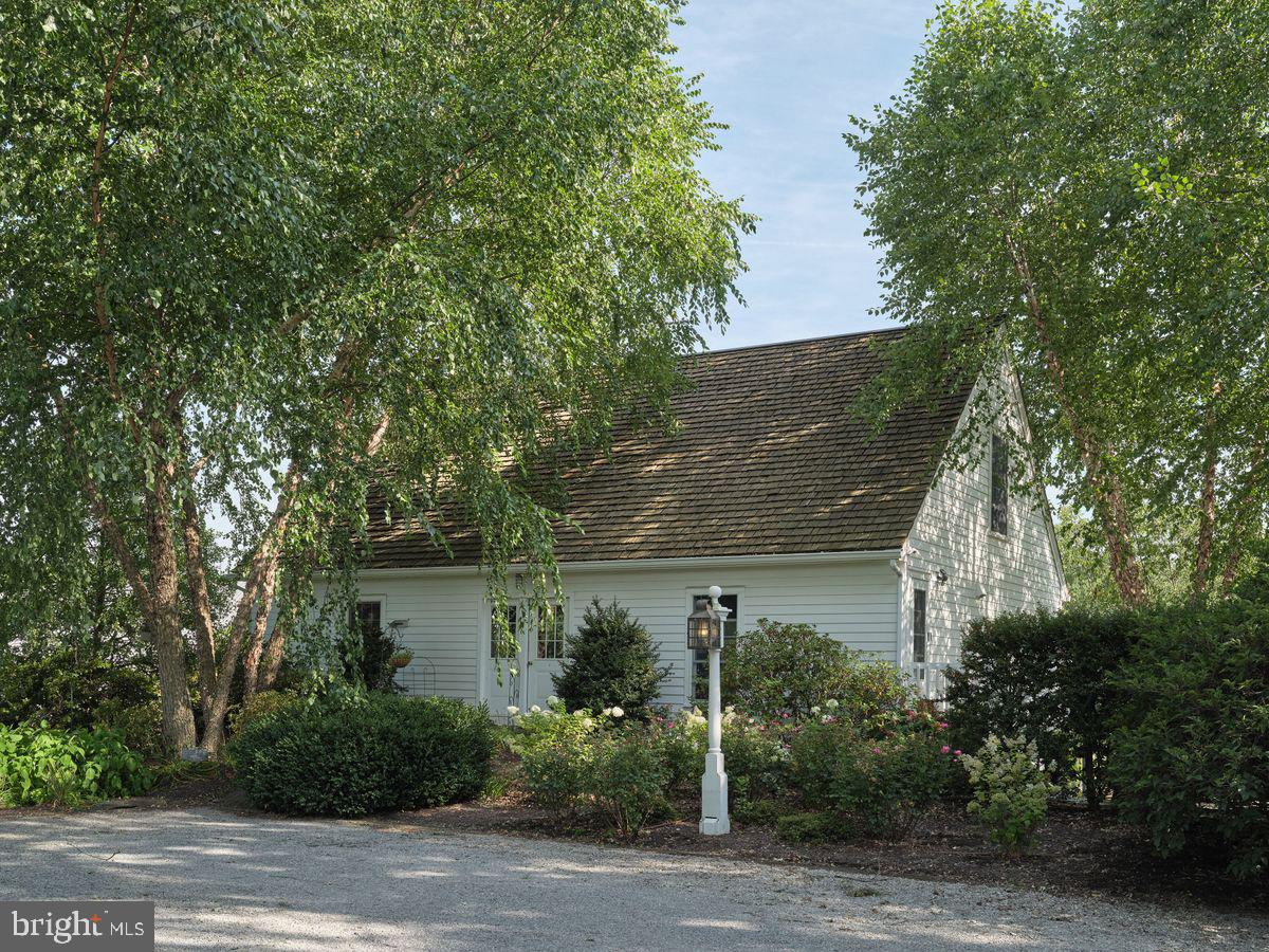 a front view of a house with trees