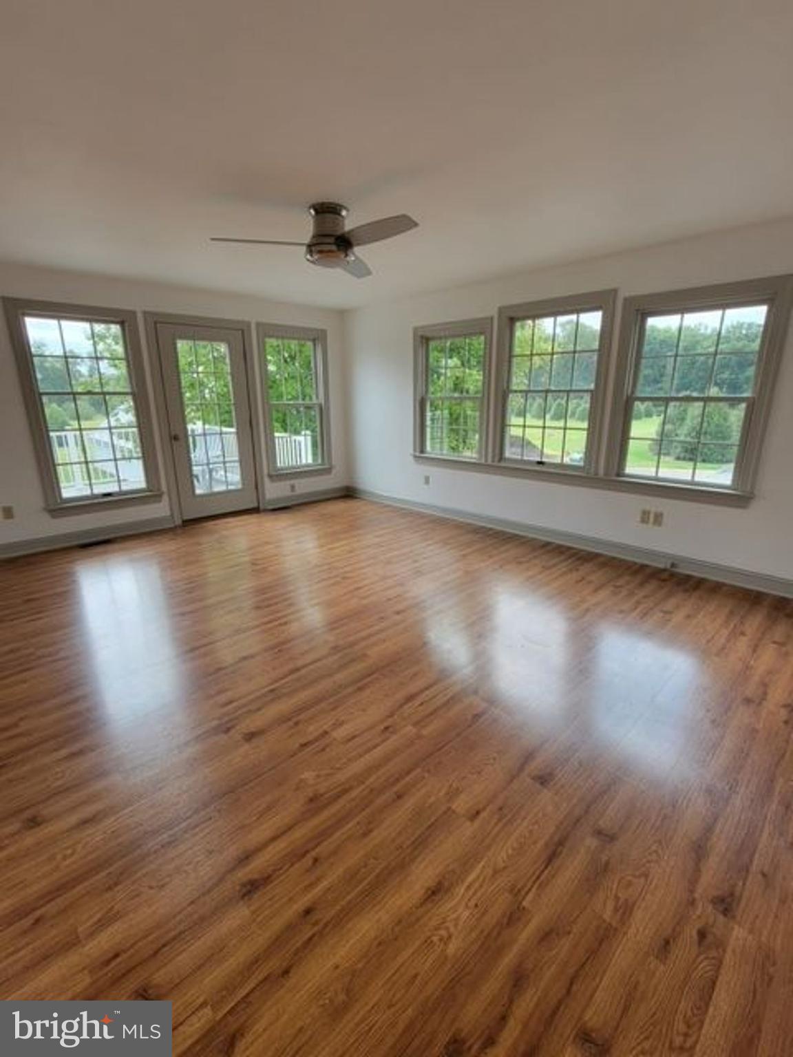 33 Rittenhouse Road, Unit E Stockton, NJ 08559 - Photo 8 of 15 a view of an empty room with wooden floor and a window