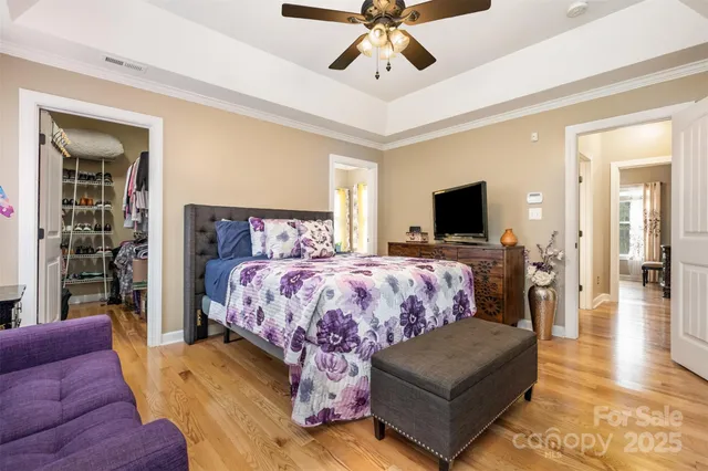 a bed room with a bed window and a flat screen tv