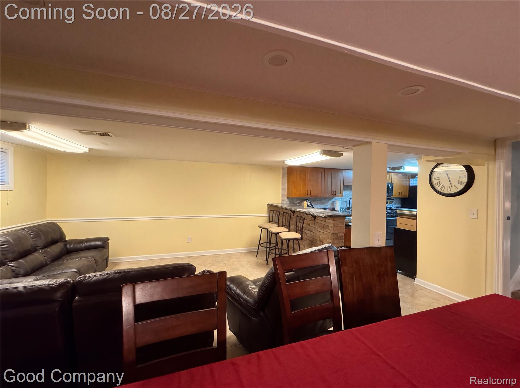 17941 East 13 Mile Road Fraser, MI 48026 - Photo 18 of 32 Open-concept recreational space featuring recessed lighting, a built-in wet bar with a stone-finish facade, and wood-finish cabinetry
