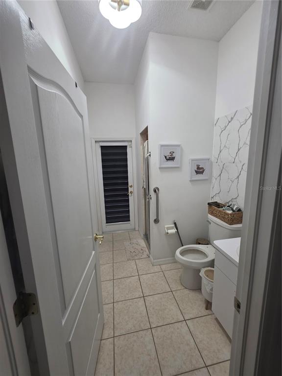17820 Monteverde Drive Spring Hill, FL 34610 - Photo 18 of 42 a bathroom with a toilet and a shower