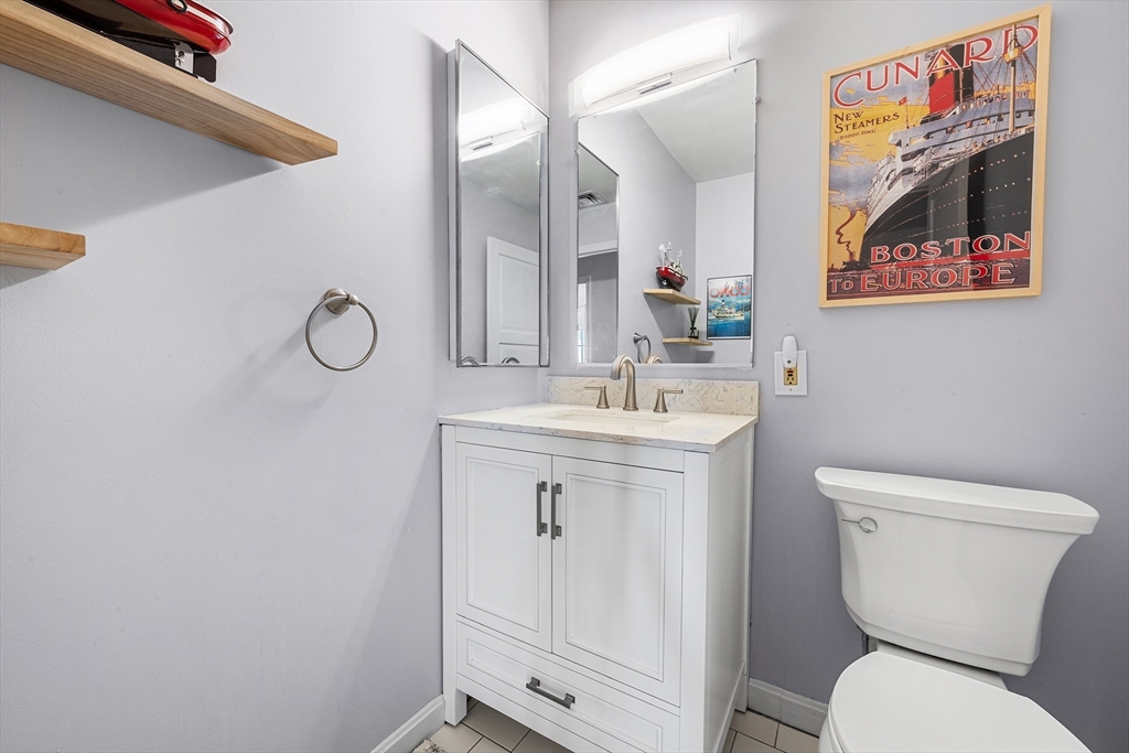63 Garden Road, Unit C5 Wellesley, MA 02481 - Photo 13 of 30 a bathroom with a toilet a sink and mirror