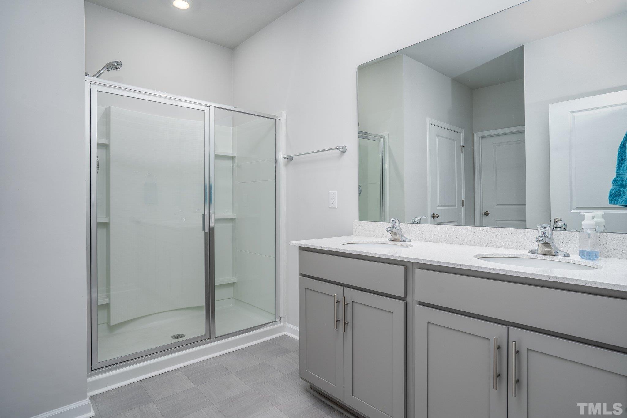 369 Lothian Rocky Mount, NC 27804 - Photo 24 of 32 a bathroom with a double vanity sink mirror and shower