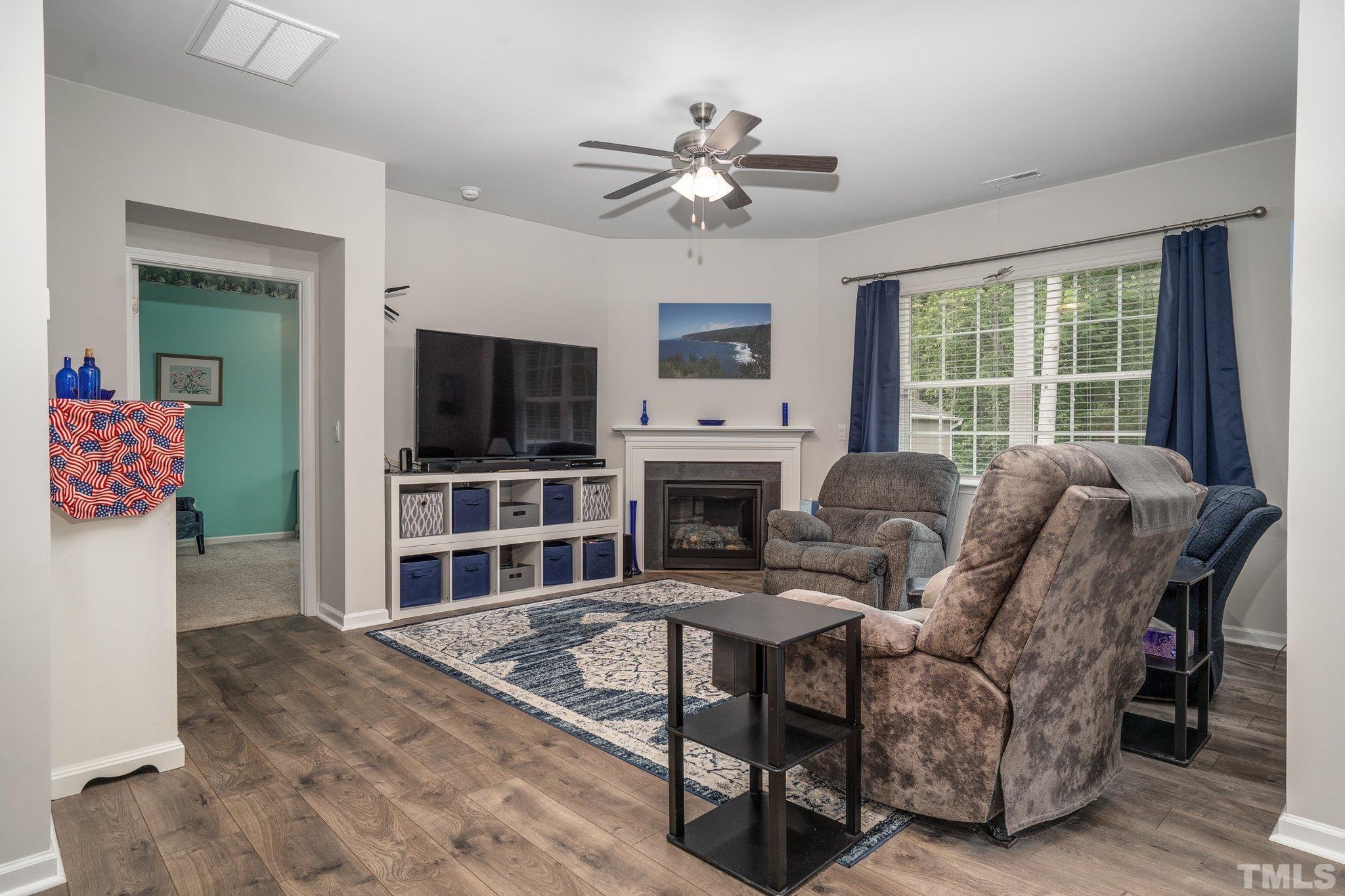 369 Lothian Rocky Mount, NC 27804 - Photo 3 of 32 a living room with furniture a flat screen tv and a fireplace