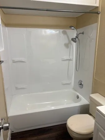 a bathroom with a toilet bathtub and shower