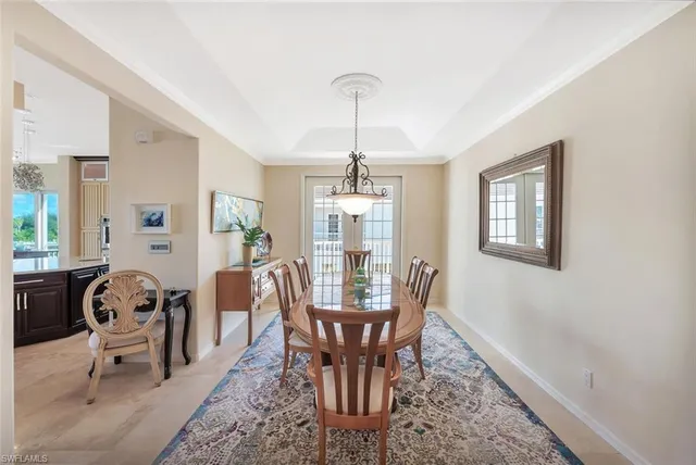 a dining room with furniture window and wooden floor
