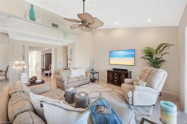 a living room with furniture a large window and a flat screen tv