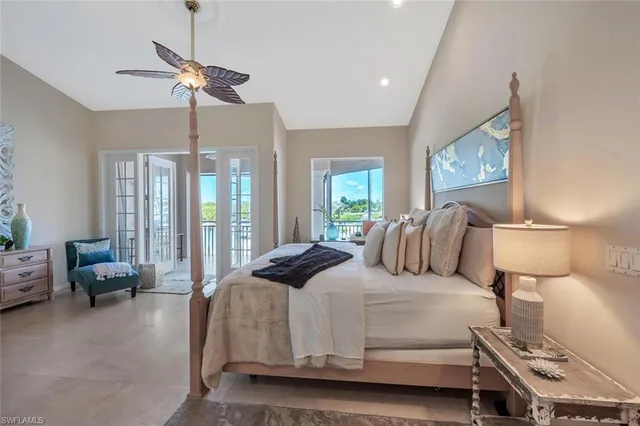 a bedroom with a bed couch and a large window